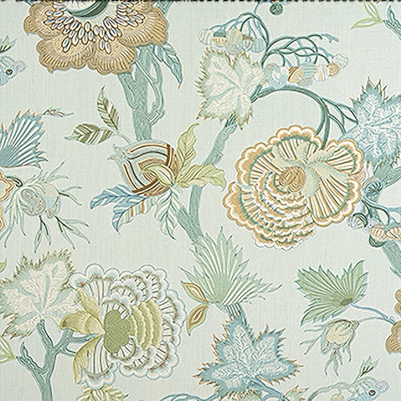 May include: A light blue fabric with a repeating pattern of stylized flowers in shades of green, brown, and beige. The flowers have a delicate, intricate design.