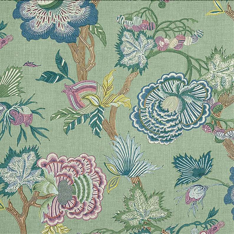 May include: A green fabric with a floral pattern featuring blue, pink, and yellow flowers. The flowers are stylized and have a whimsical, almost cartoonish look. The fabric has a textured surface.