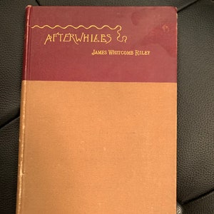 May include: A vintage book titled "Afterwhiles" by James Whitcomb Riley. The book has a maroon cover with gold lettering and a brown spine.
