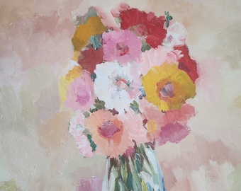 May include: A bouquet of pink, white, yellow, and red flowers in a clear glass vase. The flowers are arranged in a loose, informal style, and the vase is sitting on a light pink background.
