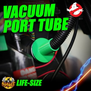 May include: Green plastic vacuum port tube with a black corrugated hose attached. The tube is labeled "LIFE-SIZE" and has a "no ghost" symbol with a ghost inside.