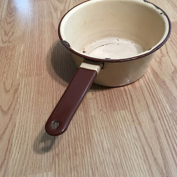 small yellow enamelware pan with brown trim