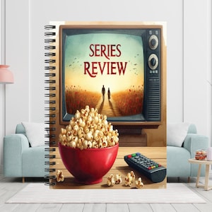 May include: A spiral-bound notebook featuring a cover illustration of a vintage television displaying the text SERIES REVIEW above a landscape with two figures, a red bowl filled with popcorn, and a black remote control on a wooden surface.