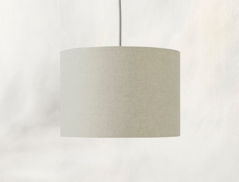 May include: A light beige drum-shaped lampshade with a linen texture.