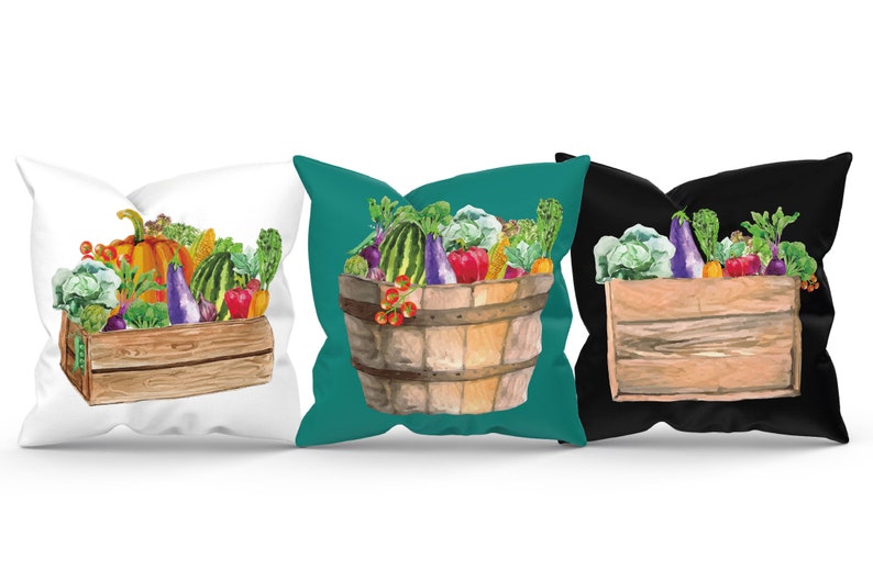 May include: Three different pillow designs featuring a watercolor illustration of a wooden crate filled with various vegetables, including a pumpkin, eggplant, watermelon, and cabbage. The crates are on a white, teal, and black background.