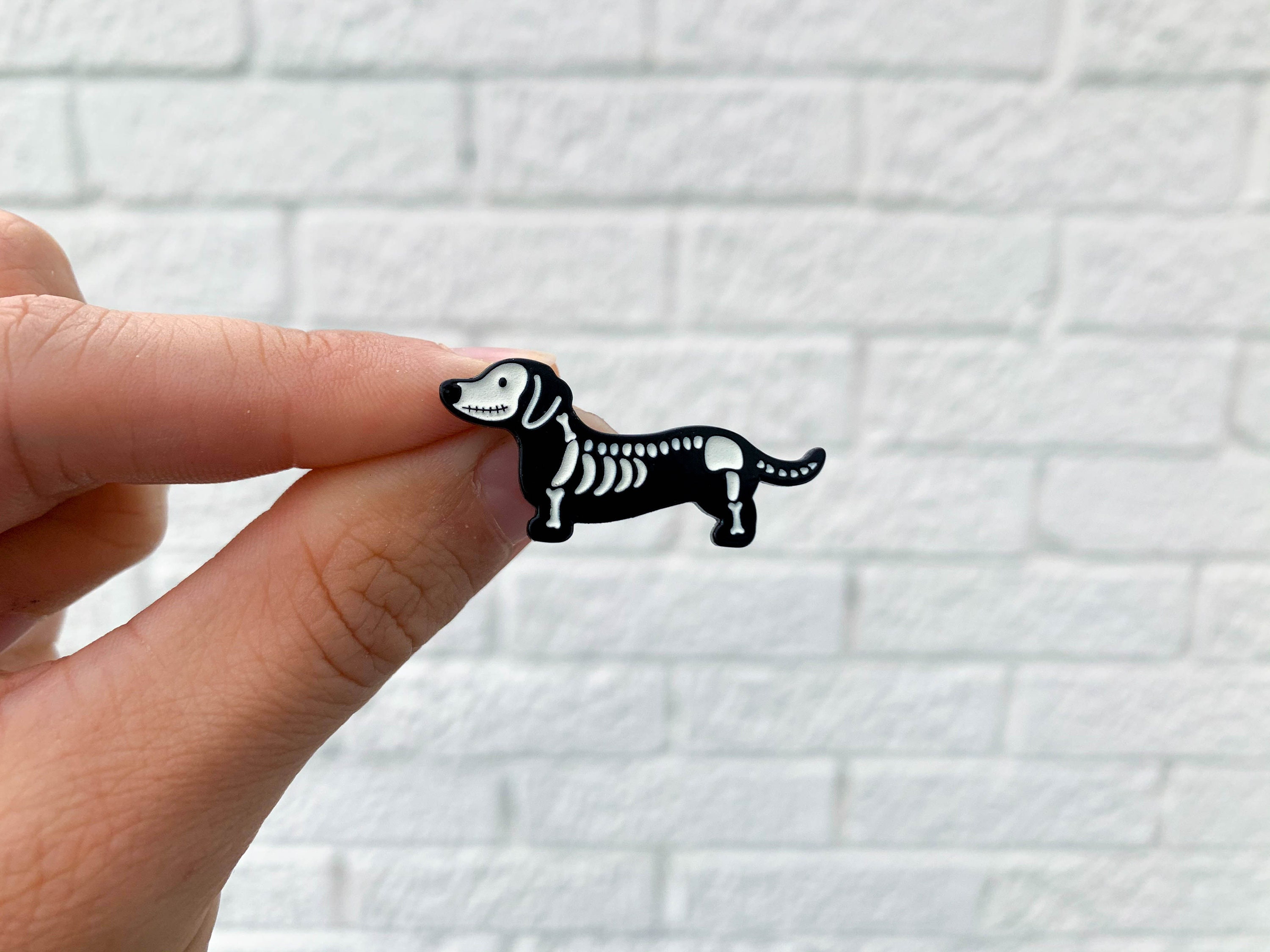 Dachshund dog pin, pewter look, pink eyes, very nice finish.