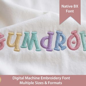 May include: Close-up of a white fabric with the embroidered word "Gumdrop" in pastel colors. The text is in a playful, rounded font. The image also includes text that reads "Native BX Font" and "Digital Machine Embroidery Font Multiple Sizes & Formats."