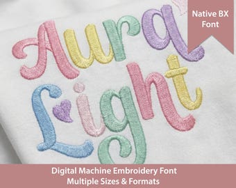 May include: A white fabric surface featuring machine embroidery in pastel colours. The text reads Aura Light in a cursive font, with a small heart icon. A pink banner in the corner displays the text Native BX Font, and the bottom text reads Digital Machine Embroidery Font Multiple Sizes & Formats.