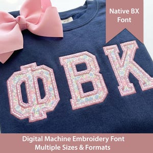May include: Navy blue sweatshirt with the letters ΦBK in a floral pattern, outlined in pink. A large pink bow sits at the top left. Text on the image reads "Native BX Font" and "Digital Machine Embroidery Font Multiple Sizes & Formats."