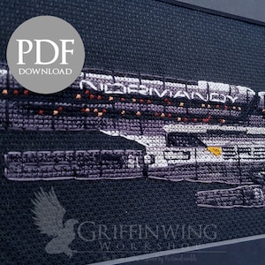 May include: Cross-stitch of the spaceship Normandy from the video game Mass Effect. The ship is rendered in shades of purple, grey, and white, with orange and yellow accents. The text "NORMANDY" is visible. The image includes a "PDF DOWNLOAD" graphic.