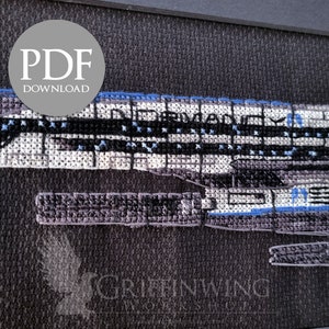 May include: Cross-stitch pattern of a spaceship design in black, white, and blue. The text "PDF DOWNLOAD" is in a gray circle. The word "INHERITANCE" is visible on the ship. The Griffinwing Workshop logo is in the bottom corner.