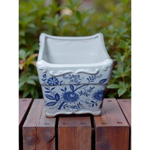 May include: A trio of ceramic mugs with a speckled, matte finish in cream, light grey, and dark grey. Each mug features a simple, minimalist design, ideal for tea or coffee.