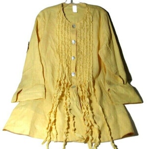 May include: A yellow linen blouse with a ruffled front and button closure. The blouse has long sleeves and a relaxed fit.