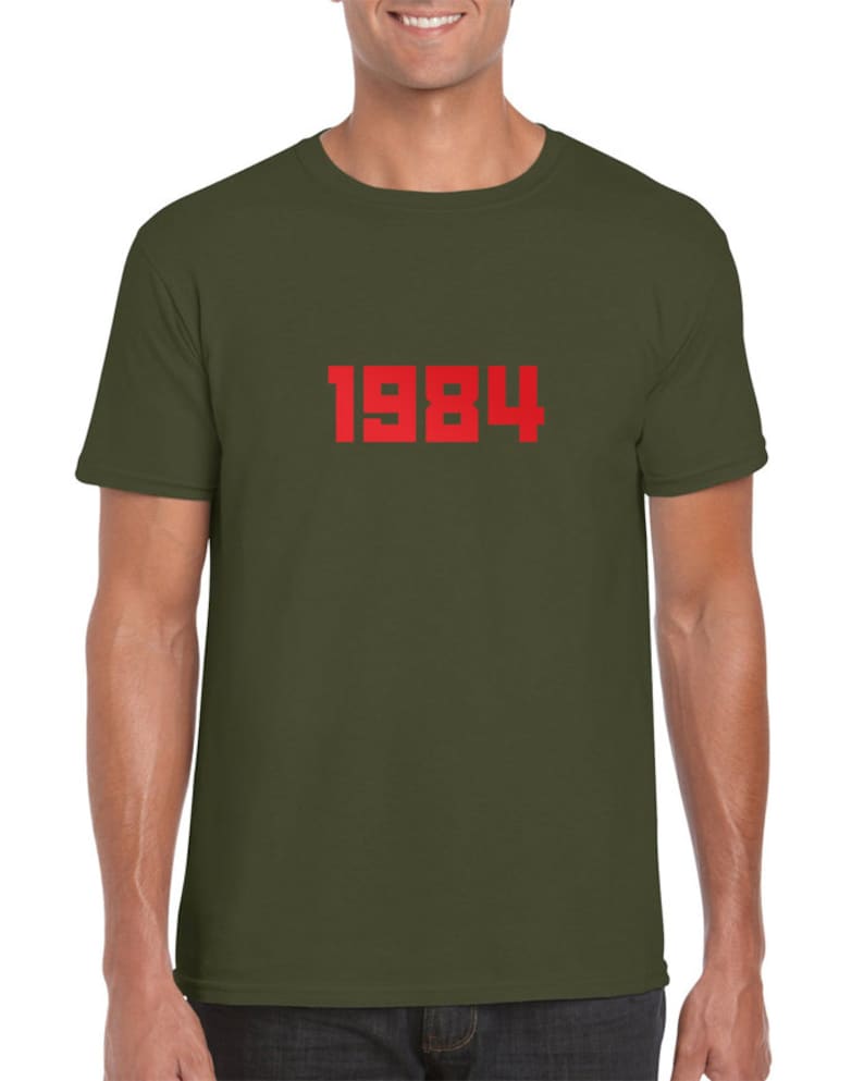 May include: A green t-shirt with the number 1984 printed in red on the front.
