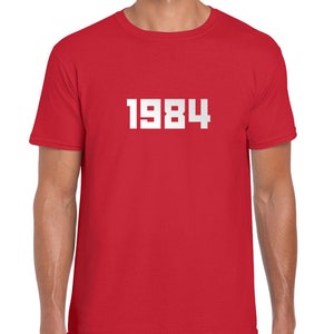 May include: Red t-shirt with white text that says "1984".