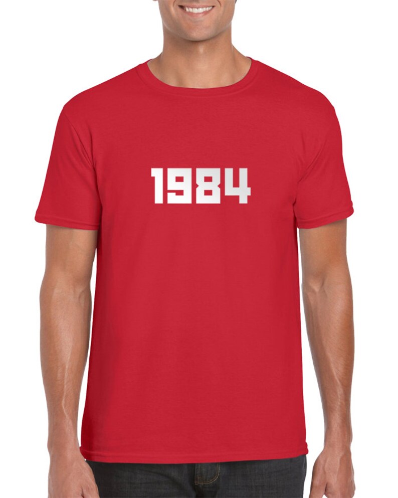 May include: Red t-shirt with white text that says "1984".