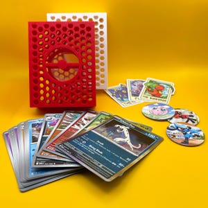 Ultimate Pokémon Mystery Bundle & Pokéball Deck Box - Includes 20 cards (4-5 holos), 3 Stickers, 3 POGs, and deck box!