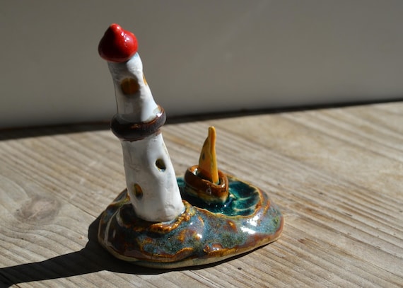 Mini ceramic lighthouse on island
