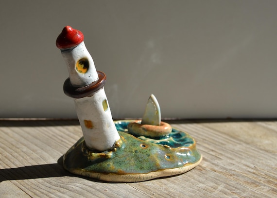 Mini ceramic lighthouse on island