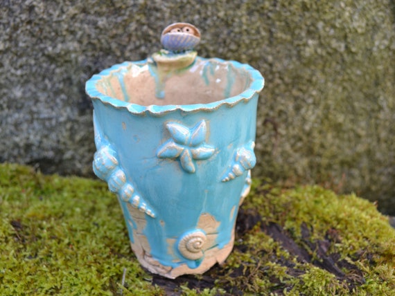 Ceramic vase shells on the beach