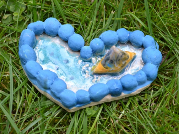Mini ceramic heart boat in the sea