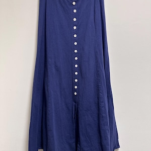 May include: A long, navy blue skirt with a button-up front and a slight A-line shape.