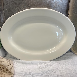 May include: A set of three ceramic mugs with a speckled, matte finish. Each mug features a different color: light blue, cream, and gray. The mugs have a simple, modern design and a comfortable handle.