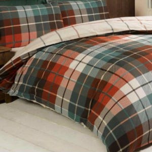 May include: A duvet cover and pillow set with a tartan design in red, teal, grey, and white. The bedding has a traditional, comfortable style. The set includes a duvet cover and two pillowcases.