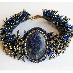 May include: A beaded bracelet featuring a large, oval, dark blue stone as the centerpiece. The bracelet is adorned with gold and dark blue beads, creating a textured and ornate design. The clasp is gold-toned.