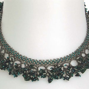 May include: A handcrafted necklace featuring a dark gray beaded design with accents of teal beads. The necklace has a unique openwork pattern and is adorned with dark green, irregularly shaped beads, creating a striking visual effect. This piece is a statement jewelry item.