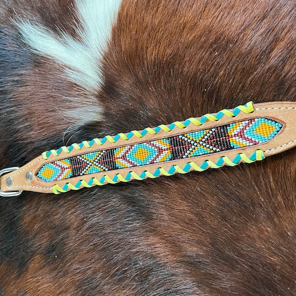 Leather dog collar with teal, white, yellow and burgundy navajo beaded design, a rawhide wrapped edge and copper hardware.