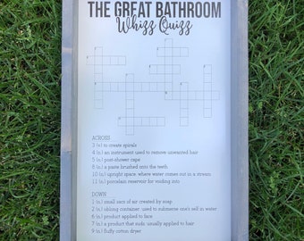 Puede incluir: Un crucigrama enmarcado en blanco con el título "The Great Bathroom Whizz Quizz". El crucigrama tiene 11 pistas horizontales y 9 pistas verticales.