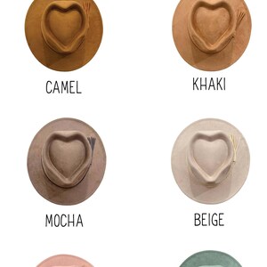 May include: A collection of six vegan suede hats for youth, each with a heart-shaped crown. Colors include camel, khaki, mocha, beige, dusty pink, and thicket. The hats have a wide brim and a tassel.