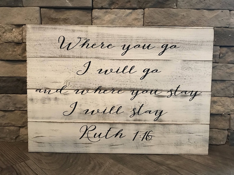 May include: White wooden sign with black lettering that reads "Where you go I will go and where you stay I will stay Ruth 1:16".