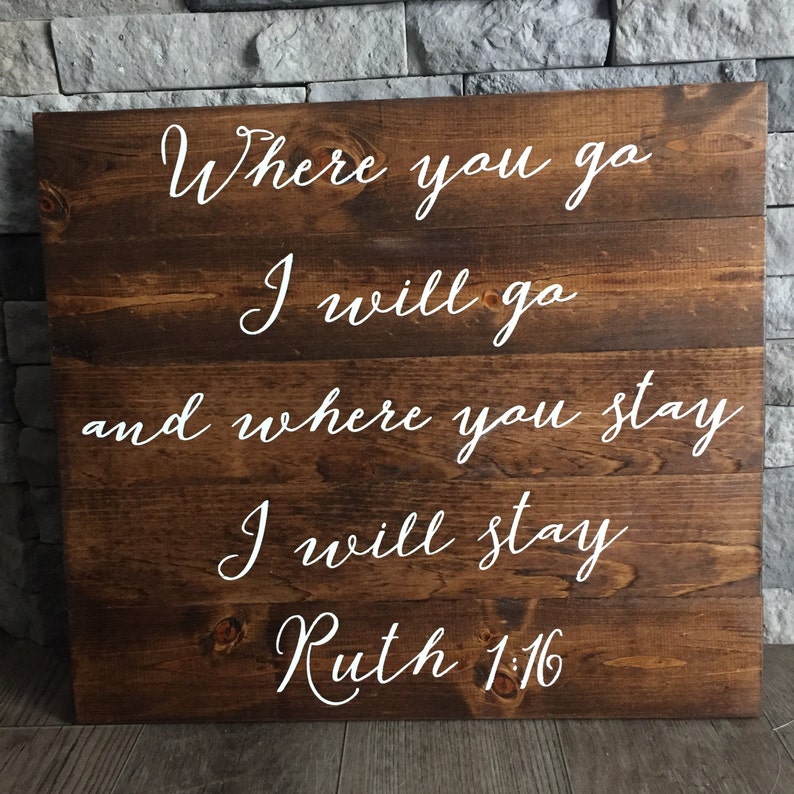 May include: A wooden sign with the text "Where you go I will go and where you stay I will stay Ruth 1:16" in white lettering.