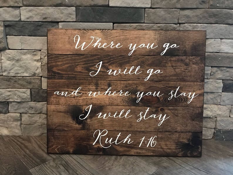 May include: A wooden sign with the text "Where you go I will go and where you stay I will stay Ruth 1:16" in white cursive lettering.