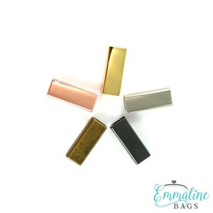 May include: Six metal slider buckles in different finishes: gold, rose gold, silver, antique brass, black, and nickel. These buckles are great for adding a touch of style to your bags, straps, or other projects.