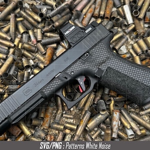 May include: A black handgun with a red dot sight and a black grip with a textured pattern. The gun is lying on a bed of spent bullet casings.