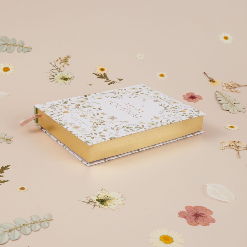 Five year mum journal with soft wildflower design, offering space to write short entries for the same day across five years and create a meaningful motherhood keepsake.