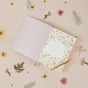 Motherhood memory book with dainty wildflower illustrations, created for mums to capture everyday life, small moments and changes across five years.