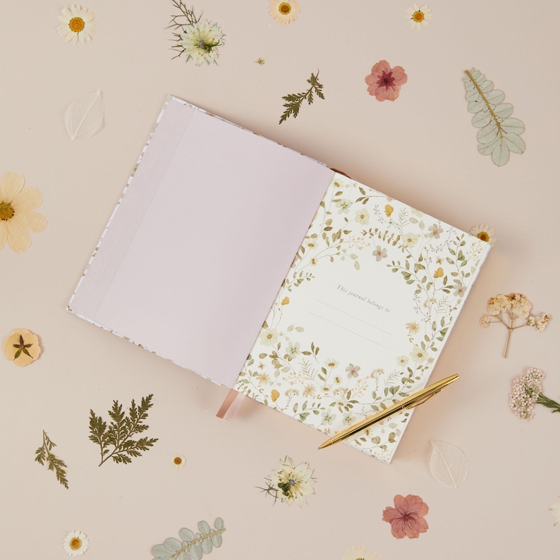 Motherhood memory book with dainty wildflower illustrations, created for mums to capture everyday life, small moments and changes across five years.
