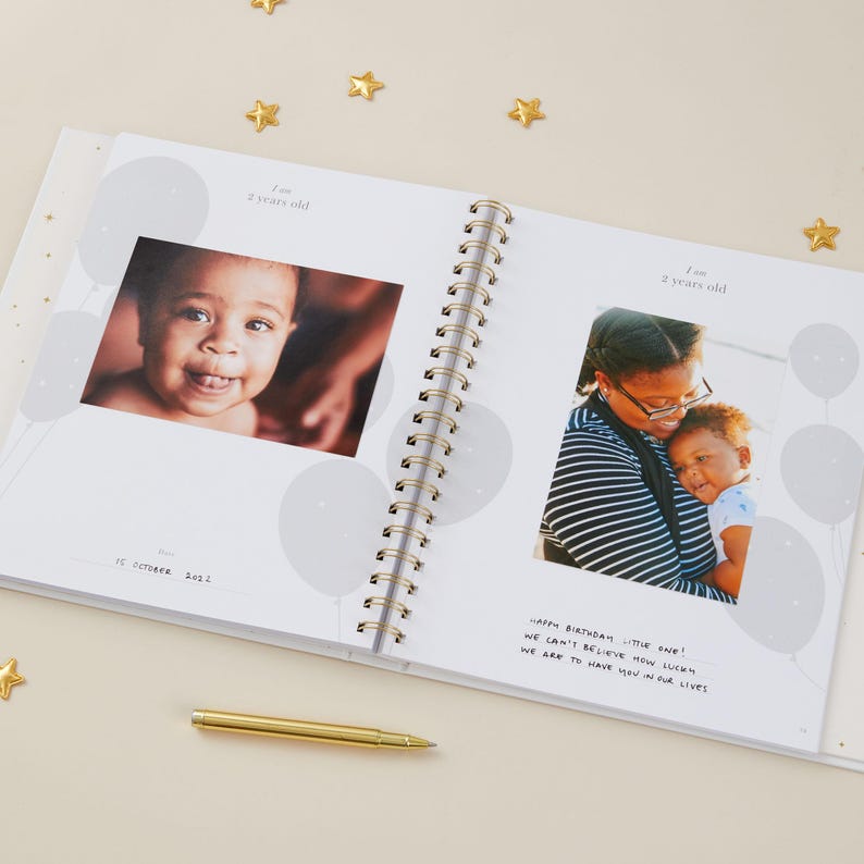 Aqua baby memory book with light blue cover and gold foiled details, designed as a milestone journal for recording memories from pregnancy through early childhood. With 114 guided pages, it helps parents capture important milestones and everyday moments with ease, while leaving room for photographs and notes. Gender-neutral and inclusive, this baby record book comes in a matching foiled presentation box, making it a beautiful baby shower keepsake.
