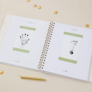 Luxury aqua baby keepsake book with gold foiled accents. Inside are 114 guided pages to help parents document milestones from pregnancy through age 5, with space for photographs and personal notes. This gender-neutral baby record book is designed to be inclusive for all families. With its timeless cloth cover and foiled gift box, this aqua baby milestone journal makes a meaningful baby shower or new parent gift.