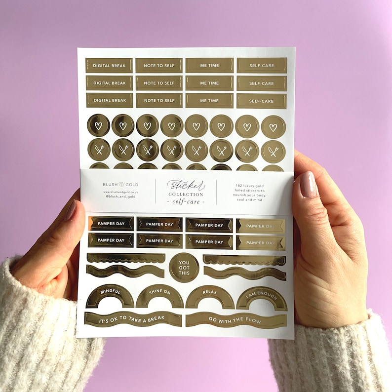 May include: A sheet of gold foiled stickers with various phrases and designs, including "Digital Break", "Note to Self", "Me Time", "Self-Care", "Pamper Day", "You Got This", "Shine On", "Relax", "I Am Enough", "It's Ok to Take a Break", and "Go With The Flow".