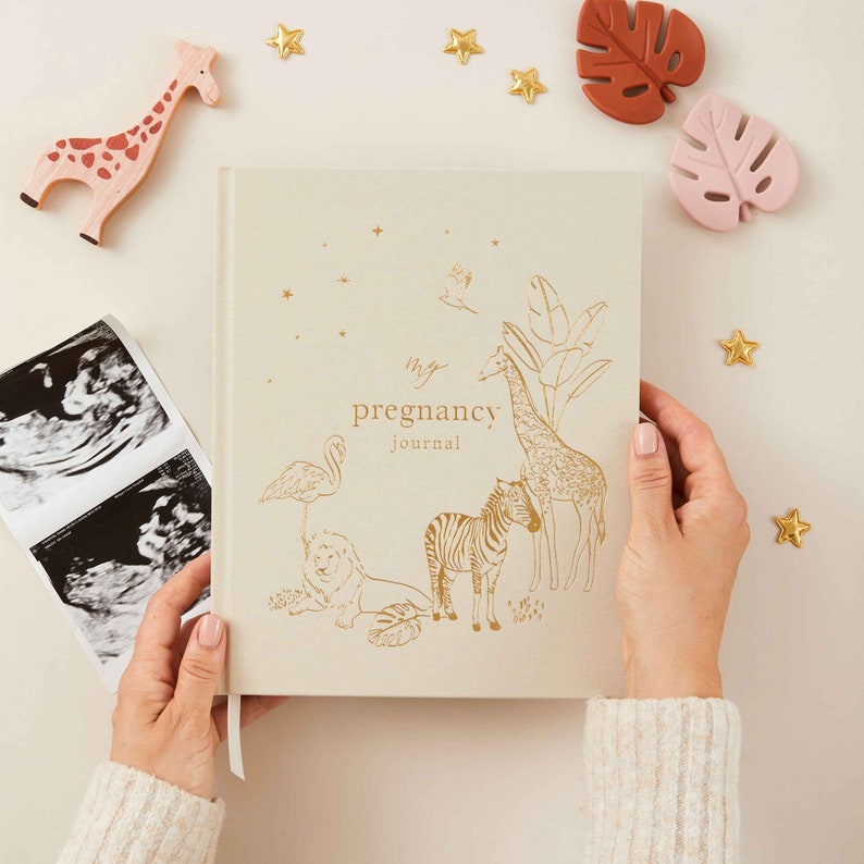Pregnancy journal with a jungle theme featuring vibrant illustrations of tropical animals and lush greenery on the cover