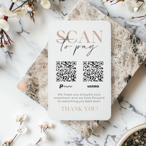 May include: A rectangular white payment sign featuring the text SCAN to pay in beige and black, two black and white QR codes for PayPal and Venmo, and the text We hope you enjoyed your treatment and we look forward to welcoming you back soon. THANK YOU!