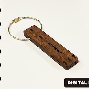 May include: A wooden keychain with a gold metal ring and the text "@HAKKOTHON" engraved on the front.