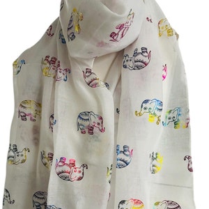 May include: White scarf with a colourful elephant print. The elephants are outlined in black and filled with rainbow colours.