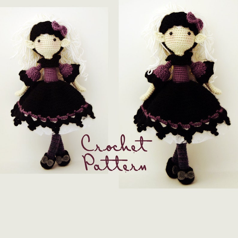 May include: A crochet doll with white hair, a purple dress, and black shoes. The doll is wearing a black hat with a white bow. The doll is standing on a white background. The text "Crochet Pattern" is written in cursive below the doll.