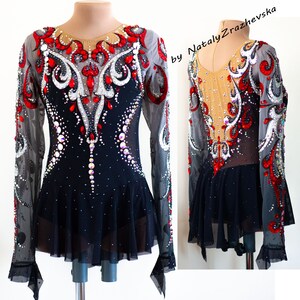 May include: A black and red figure skating dress with long sleeves, embellished with rhinestones and decorative patterns. The dress features a sheer neckline and sleeves, with a flared skirt. The design includes a combination of red, white, and clear crystals.